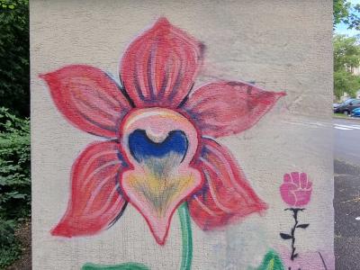 Large Pink Orchid and Flower Fist in Saint-Nectaire — Street art in Saint-Nectaire