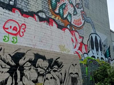 Créature verte et frise de grimaces — Street art à Berlin
