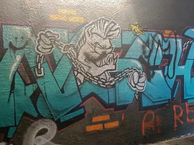 Blue Wildstyle Graffiti with Chained Character — Street art in Prague