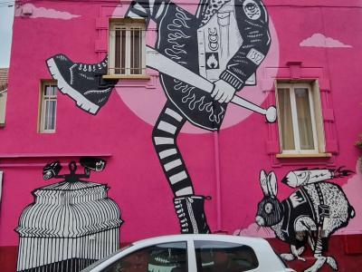 The Girl with the Bat — Street art by ERRE in Grenoble