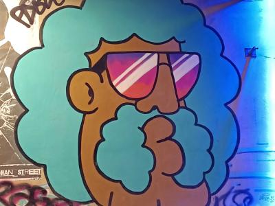 Fluorescent Blue Character with Sunglasses — Street art in Paris