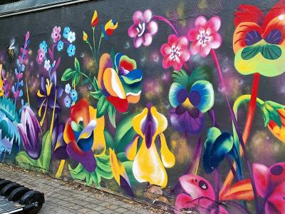 Neon Flower Garden on Dark Background — Street art in Rīga