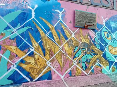 Blue Creature and Golden Tropical Foliage — Street art in Rīga