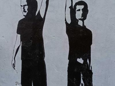 Two Silhouettes, Fist and V-Sign — Street art in Vilnius