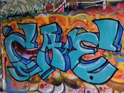 Turquoise Lettering on Orange Flames — Street art in Grenoble