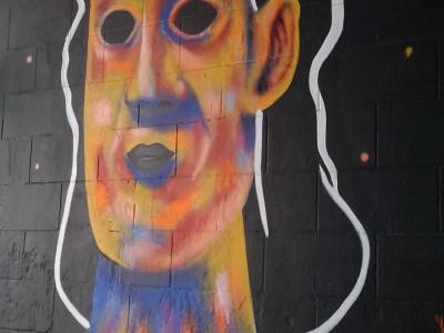 Expressive Portrait with Hollow Eyes on Black Background — Street art in Nantes