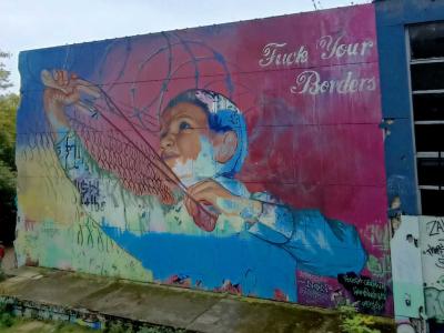 Child Pulling the Fence Apart — Street art by Alaniz in Berlin
