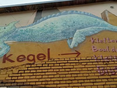 Whimsical Dinosaur on Berlin Facade — Street art in Berlin