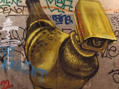 Golden Bird with Camera Head — Street art in Paris