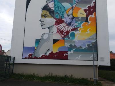 Winged Woman Colorful Clouds — Street art in Gargenville