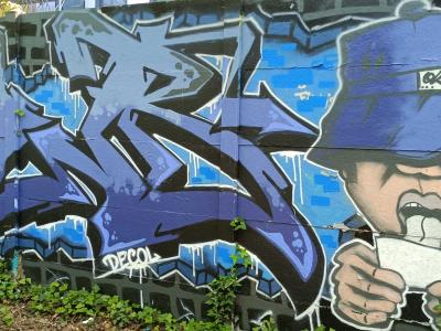 Blue Lettering and the Character in a Bucket Hat — Street art in Nantes