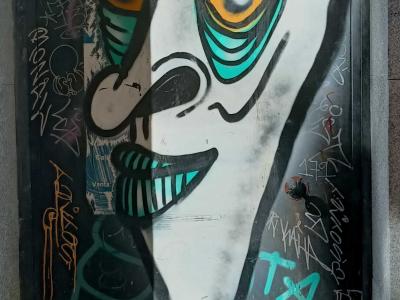 Grotesque Face with Swirling Eyes — Street art in Madrid
