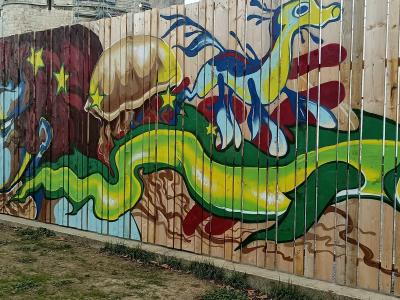 Green Lizard and Stylized Clouds — Street art in La Rochelle