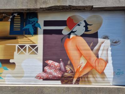 The Woman with the Wide Hat and the Basket — Street art in Vallon-Pont-d'Arc