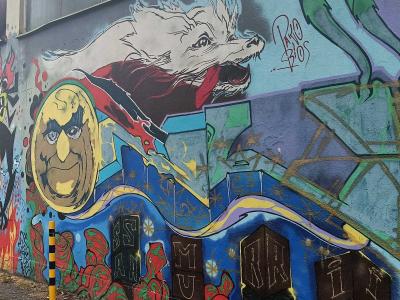 Loup blanc et personnages fantastiques sur façade — Street art à Prague