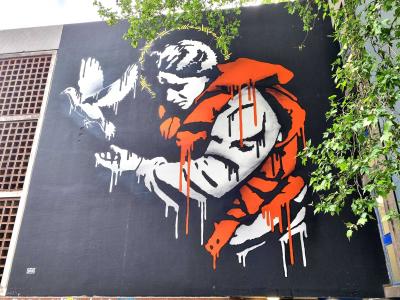 The Child and the Dove — Street art by Goin in Grenoble