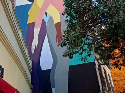 Woman Carrying a Plant by Poni — Street art by Poni (Hilda Palafox) in Madrid