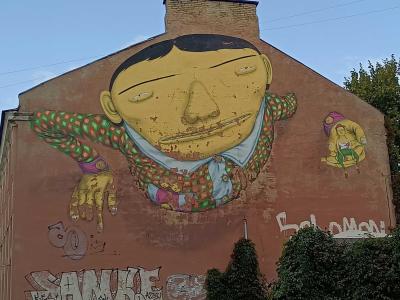 Stylized yellow face by Osgemeos — Street art by Osgemeos in Vilnius