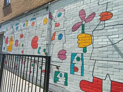 Naive Heads and Flowers by Thierry Noir — Street art by Thierry Noir in London