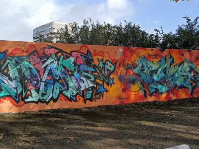 Row of Pieces on an Orange Wall — Street art in Nantes