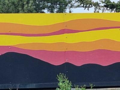 Cyclist at Volcanic Sunset — Street art in Gannat
