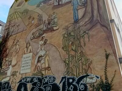 Relief mural of life in harmony — Street art in Köln