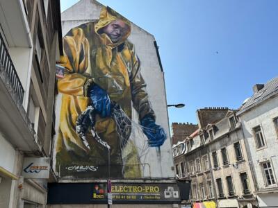 J'agis, Fisherman in a Yellow Oilskin — Street art by Jarus in Boulogne-sur-Mer