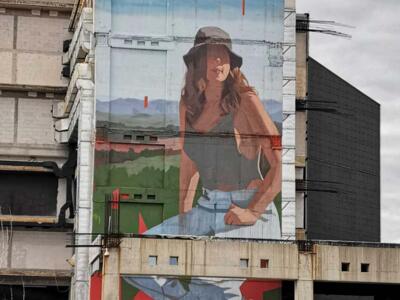 Young woman in a bucket hat in a landscape — Street art by Emmanuel Jarus in Split
