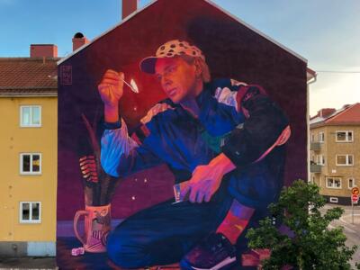 Young man striking a match — Street art by Kitsune Jolene in Vänersborg