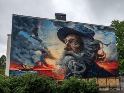 Old sailor and sailing ship at sunset — Street art by Gore in Vänersborg