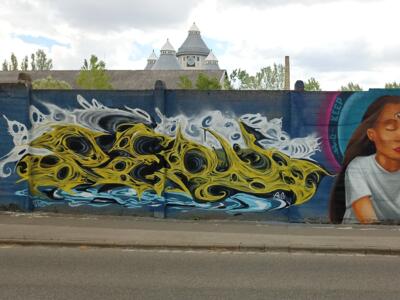 The yellow wall and the portrait with a third eye — Street art in Budapest
