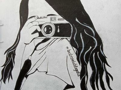 Woman Photographer with Black Hair — Street art in Madrid