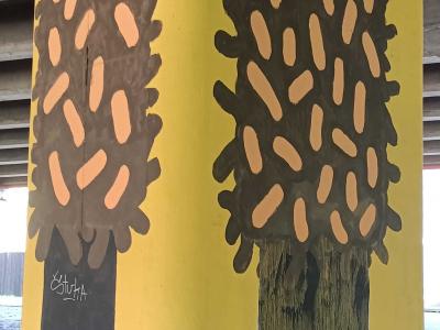 Two Simplified Trees on Yellow Pillar — Street art in Rīga