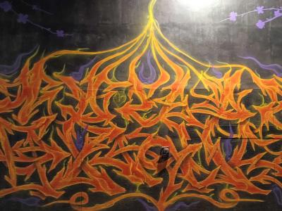 Lettrage wild style en flammes orange — Street art à Paris