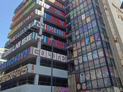 Building with Fragmented Vertical Lettering — Street art in London
