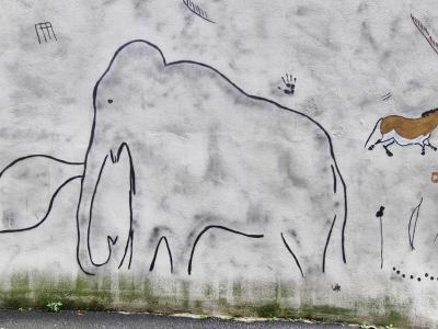Cave Painting Scene with Mammoth and Horse — Street art by Lasco in Clermont-Ferrand
