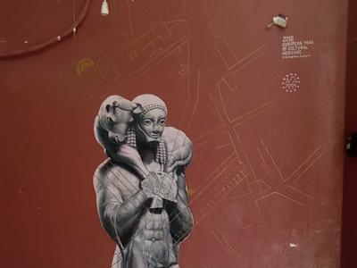 Ancient Figure Stencil on Red Wall — Street art in Athina