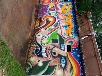 The Plant Character and the Blue Eye — Street art in Bourdeilles