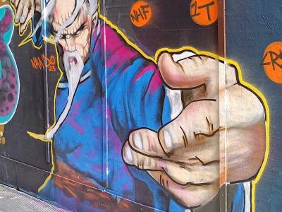 White Character with Raised Fist - Cartoon — Street art in London