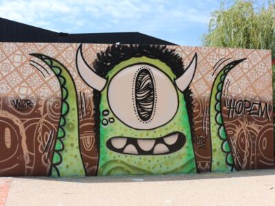 The Green Cyclops of the Skatepark — Street art by Hopem Story in Perpignan