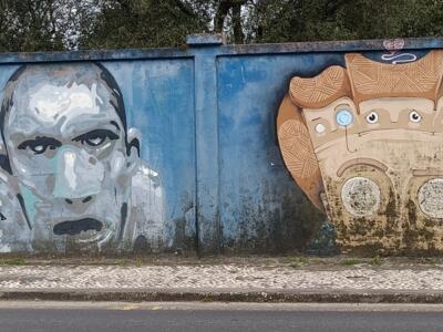 Tense face and mask with many eyes — Street art in Lisboa