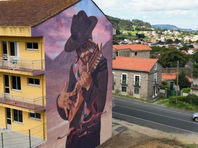Andean Charango Player — Street art by Cristóbal Persona in Fene