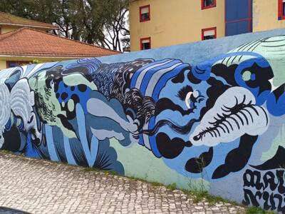 Wave of faces in black and mint — Street art in Lisboa