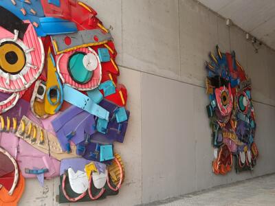 Row of Masks Under the Covered Passage — Street art by Bordalo II in Lisboa
