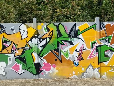 Lettrage vert et jaune à l'œil unique — Street art à Reims