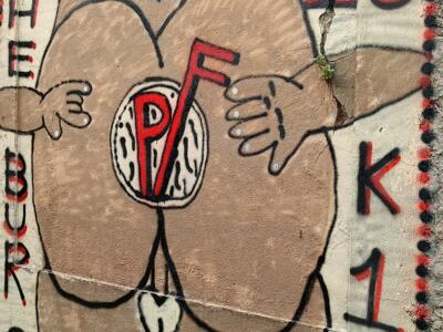 Figure with a Red Disc and K1WY Letters — Street art in Lisboa
