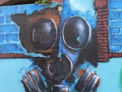 Gas Mask on a Blue Wall — Street art by Godelu in Nantes