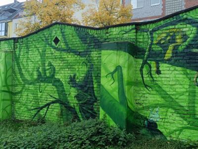 Green wall of jungle shadows — Street art by Colorrevolution e.V. in Köln