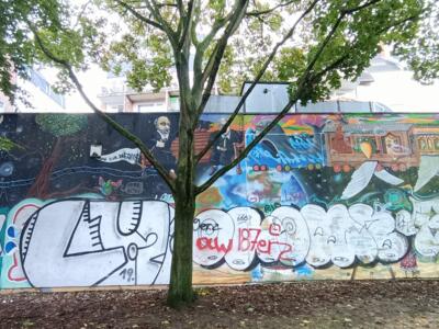 Locomotive and fairground caravan — Street art in Köln
