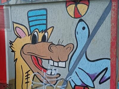 Wolf bandleader and blue bird — Street art in Yffiniac